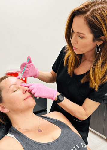 Image showing female patient being injected with botox by female doctor