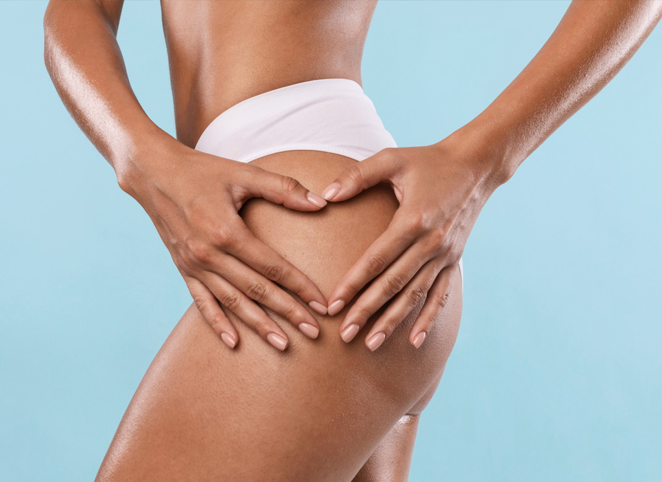 Image of a model girl showing complete left side of the leg by placing heart symbol with both hands