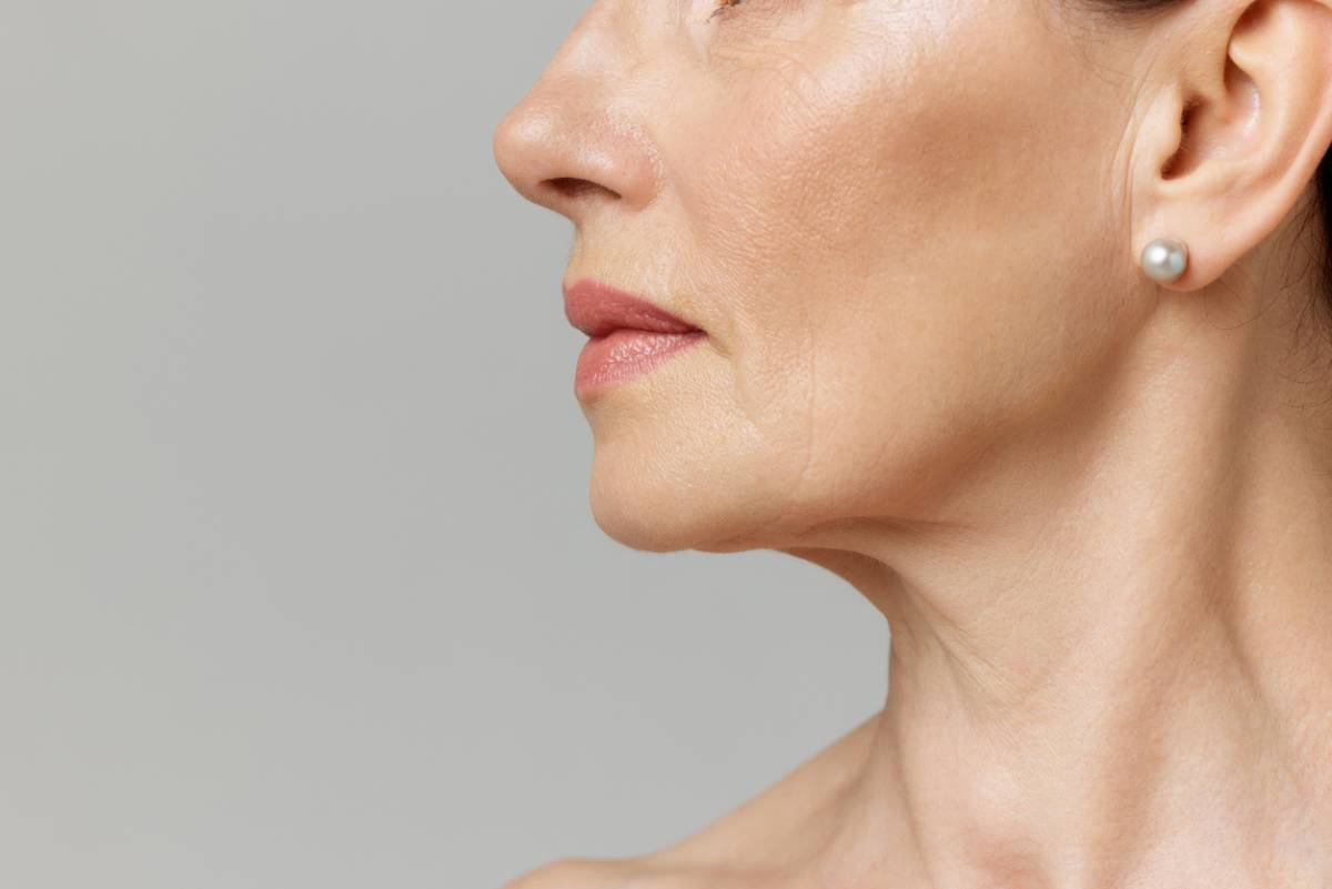 Cropped profile portrait with lips and chin neckline of middle-aged woman.